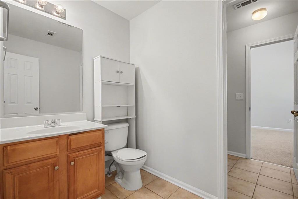 4350 Defoors Farm Trail Powder Springs, GA 30127 - Photo 22 of 35 a bathroom with a toilet sink vanity and mirror