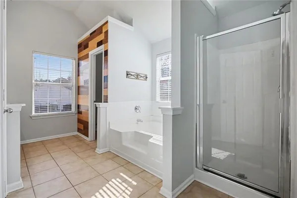 a bathroom with a sink mirror and a window