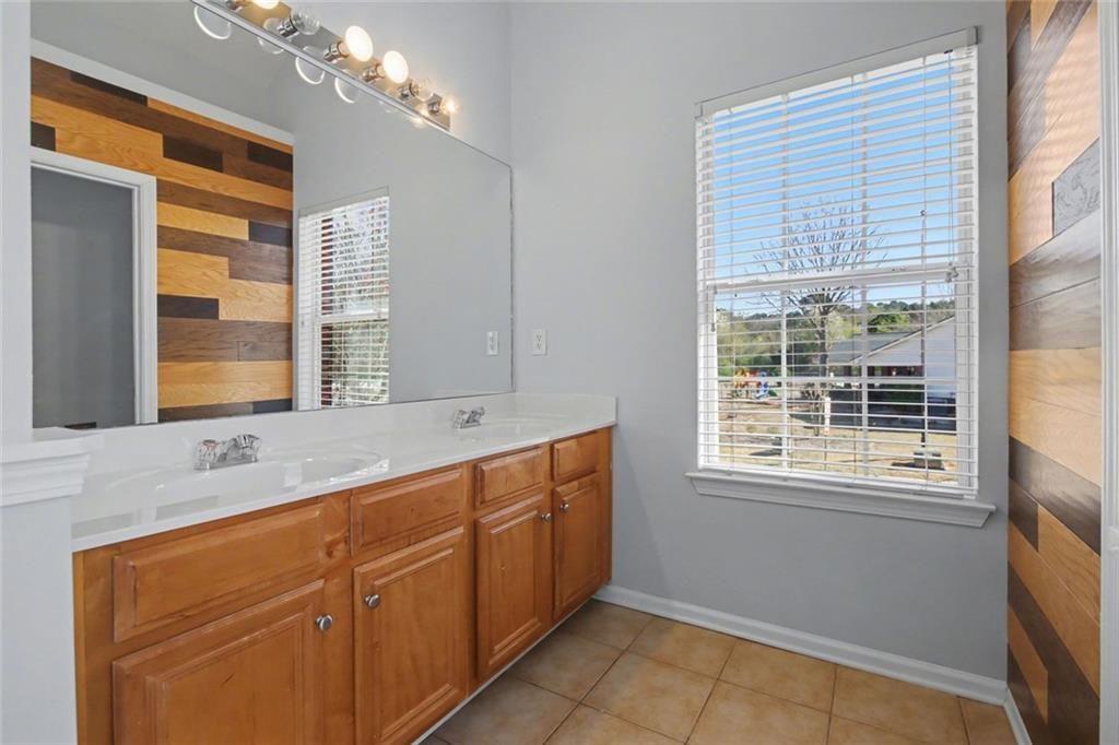 4350 Defoors Farm Trail Powder Springs, GA 30127 - Photo 29 of 35 a bathroom with a sink mirror and a window