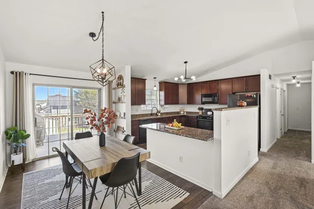 a kitchen with refrigerator and cabinets
