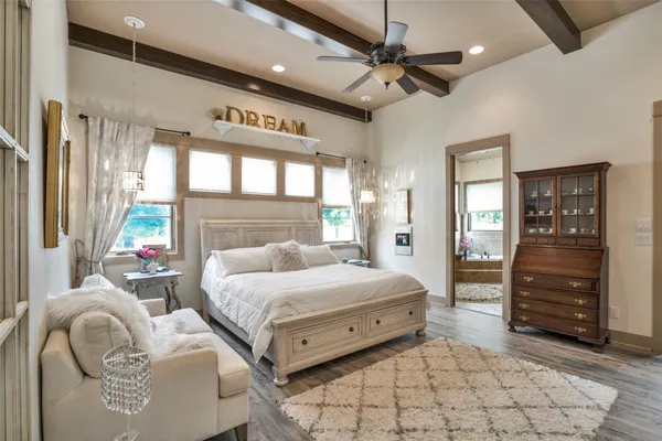 a bathroom with a granite countertop sink mirror and a bathtub