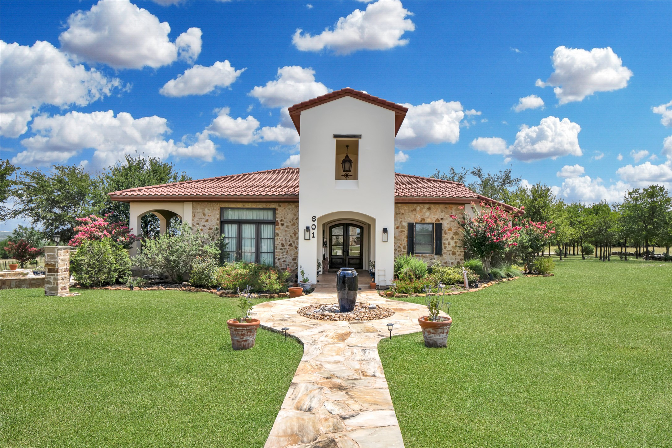 601 Strada Luca Florence, TX 76527 - Photo 2 of 40 a front view of a house with garden and a large tree