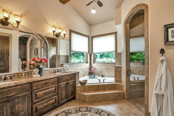 a bedroom with a bed and a large mirror