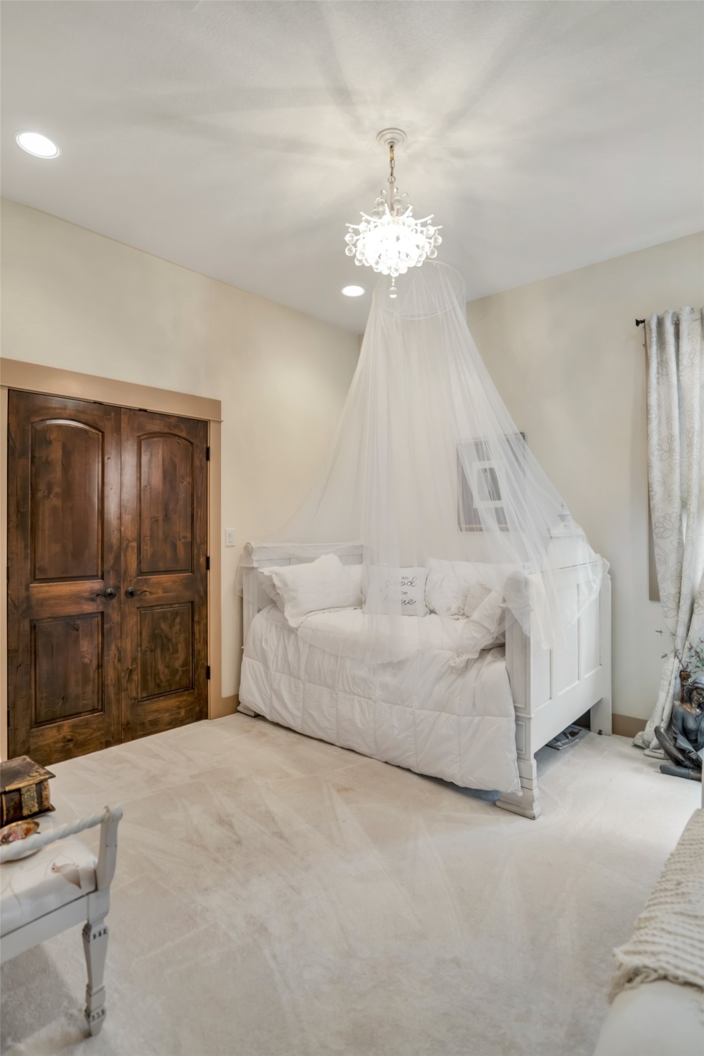 601 Strada Luca Florence, TX 76527 - Photo 25 of 40 a spacious bedroom with a bed and a chandelier