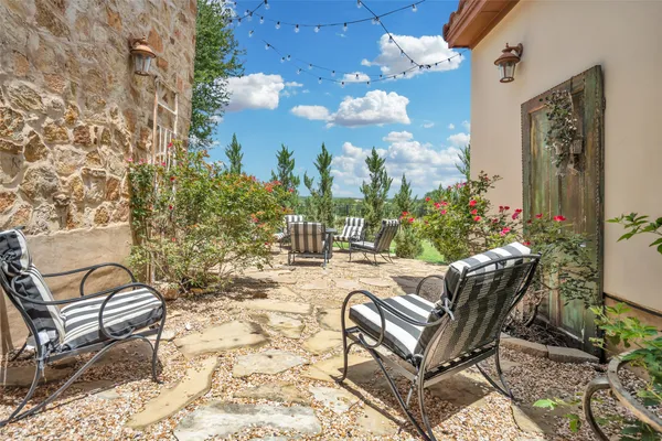 a view of a chairs and table in backyard