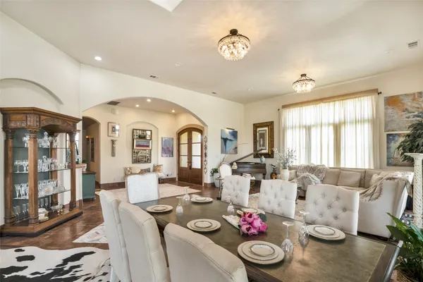 a living room with furniture and floor to ceiling windows