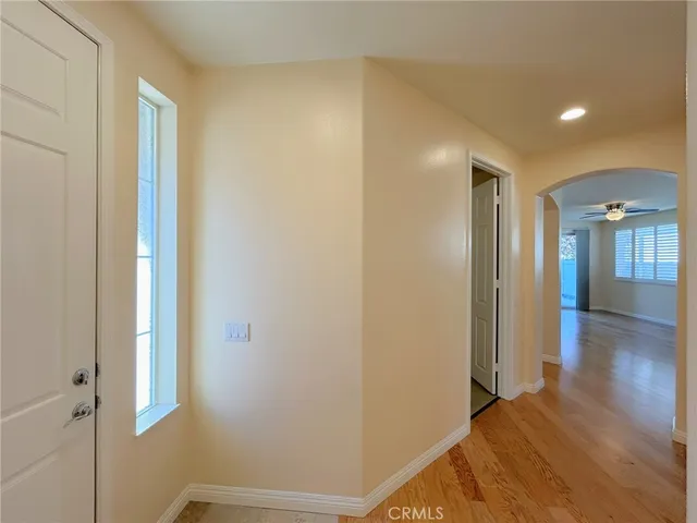 a view of a hallway with wooden floor