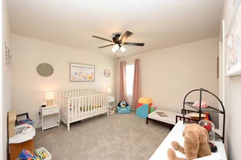 a bedroom with furniture and a large window