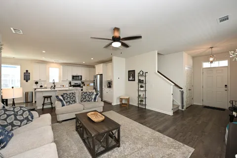 a living room with furniture and a chandelier