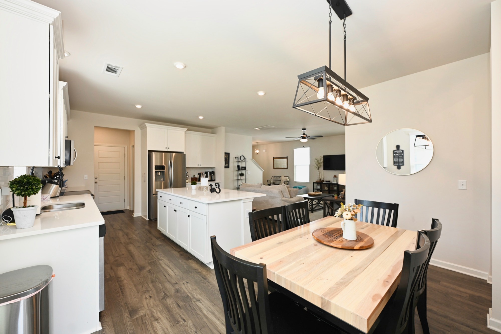 522 Red Barn Way Mount Juliet, TN 37122 - Photo 9 of 25 a open dining room with stainless steel appliances kitchen island furniture a chandelier a kitchen view and a chandelier