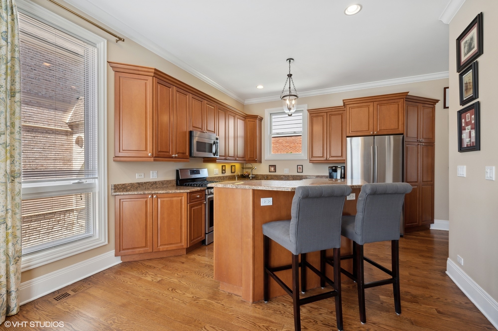 948 Green Bay Road Glencoe, IL 60022 - Photo 6 of 21 a kitchen with stainless steel appliances granite countertop a stove a refrigerator a microwave oven with a dining table and chairs