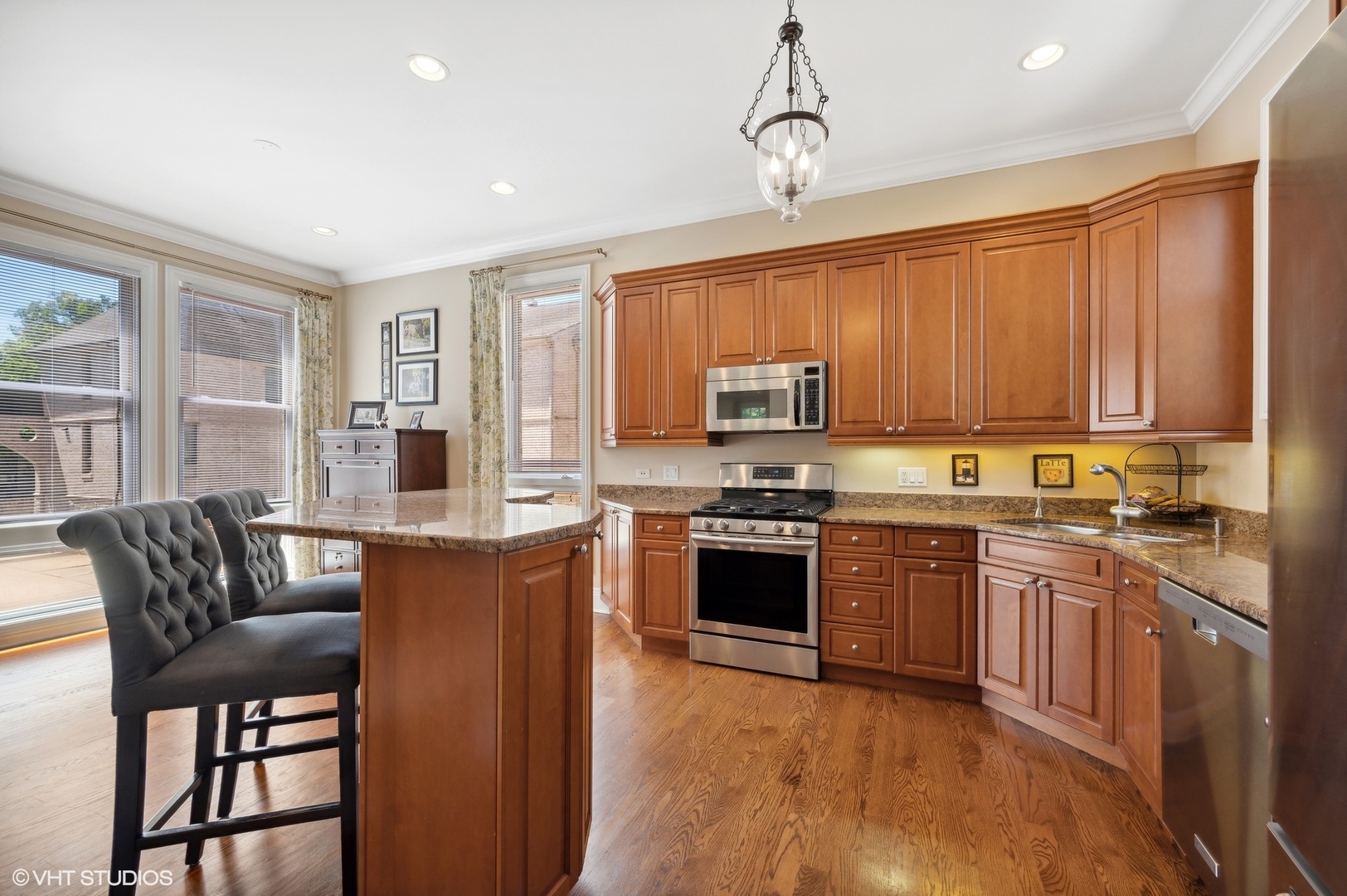 948 Green Bay Road Glencoe, IL 60022 - Photo 7 of 21 a kitchen with stainless steel appliances granite countertop a stove top oven a sink dishwasher a dining table and chairs with wooden floor