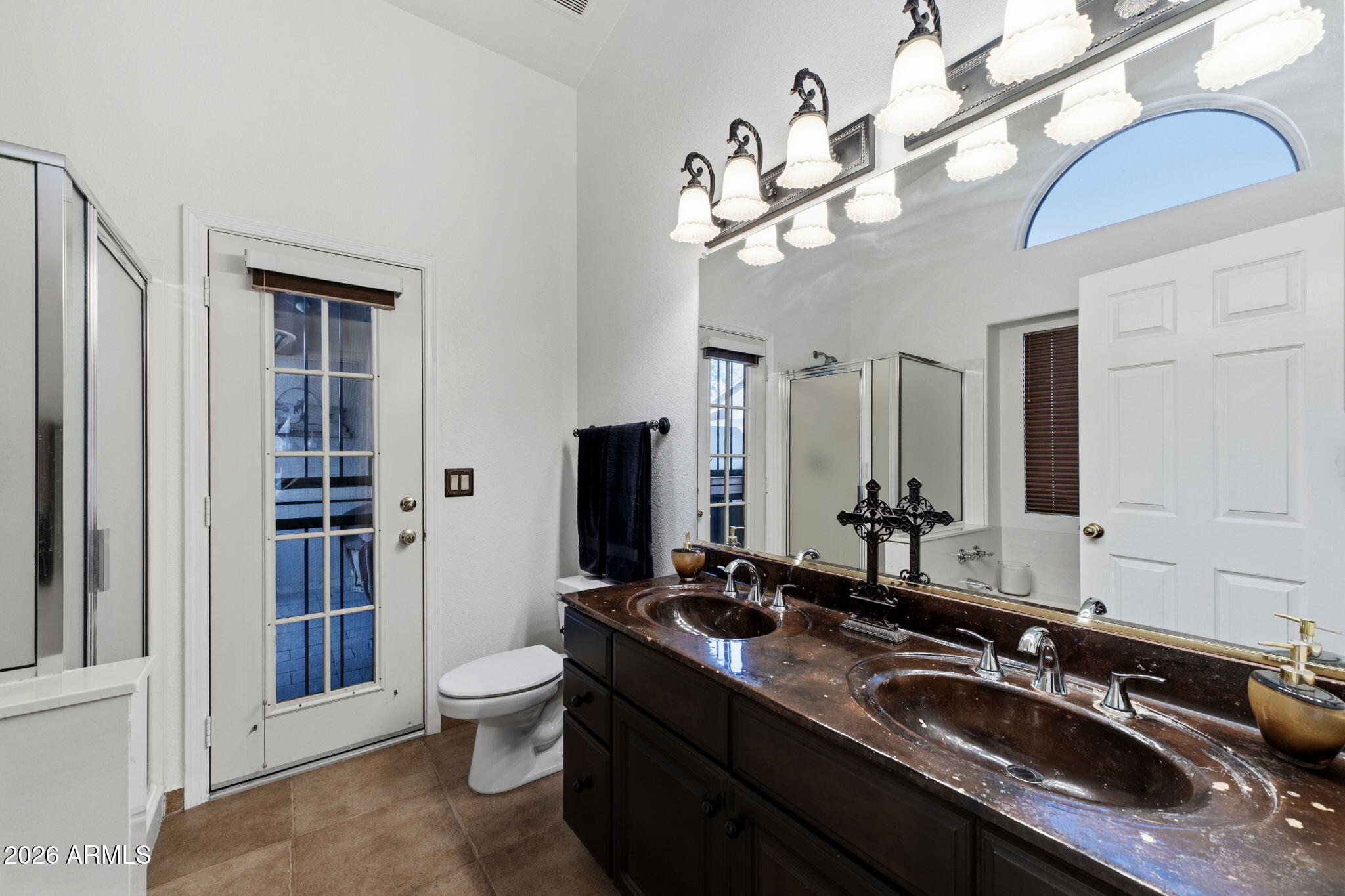 6526 East Raftriver Street Mesa, AZ 85215 - Photo 8 of 17 a bathroom with a sink a toilet and a mirror