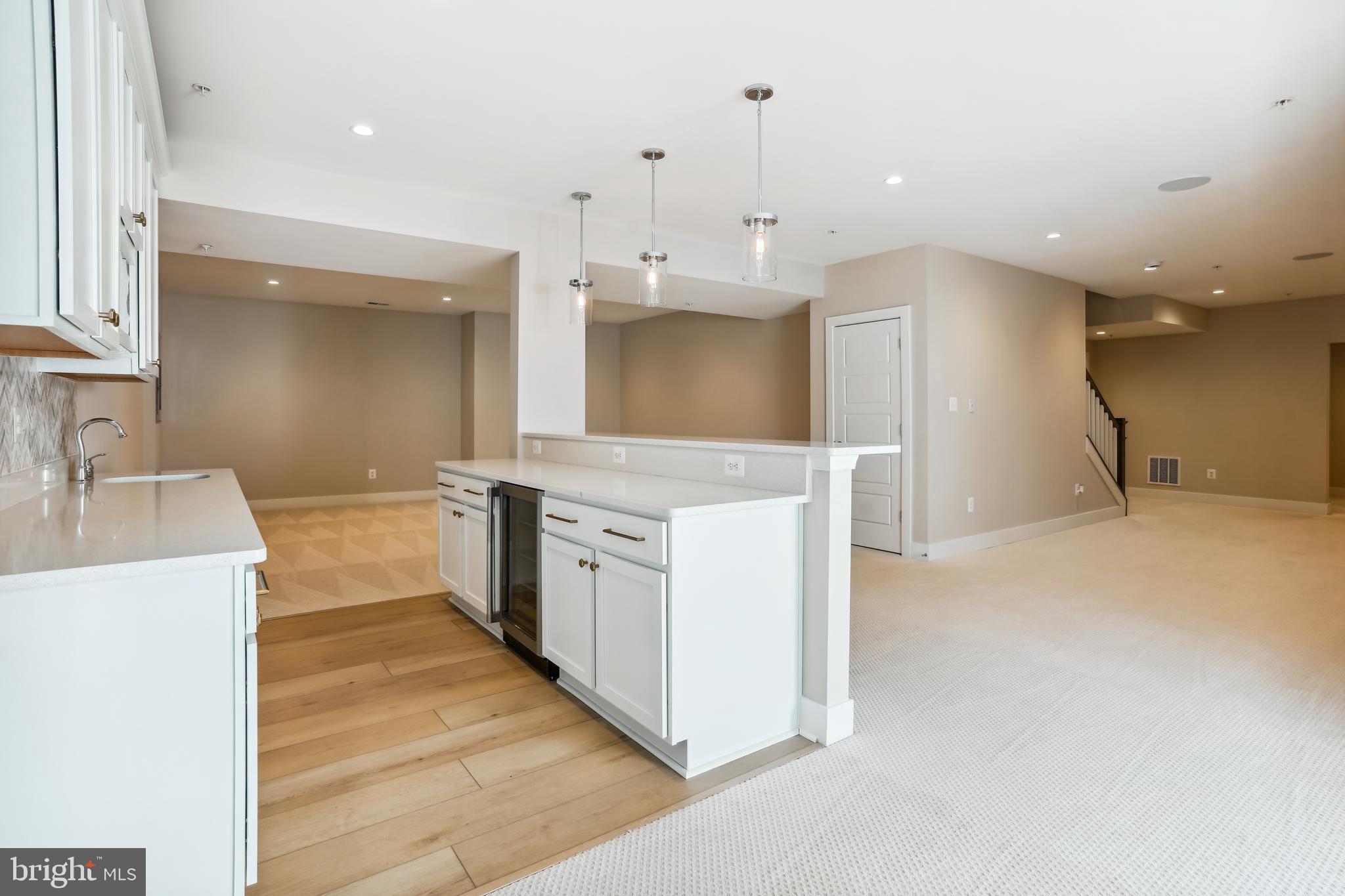 4996 Ilchester Road Ellicott City, MD 21043 - Photo 62 of 74 a large kitchen with a large counter top a sink a stove and a refrigerator