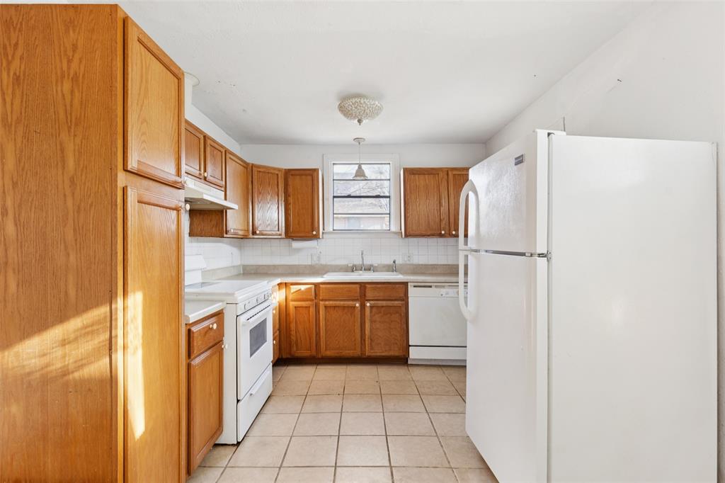1602 Bruce Drive Garland, TX 75043 - Photo 11 of 31 a kitchen with stainless steel appliances granite countertop a refrigerator and a stove top oven