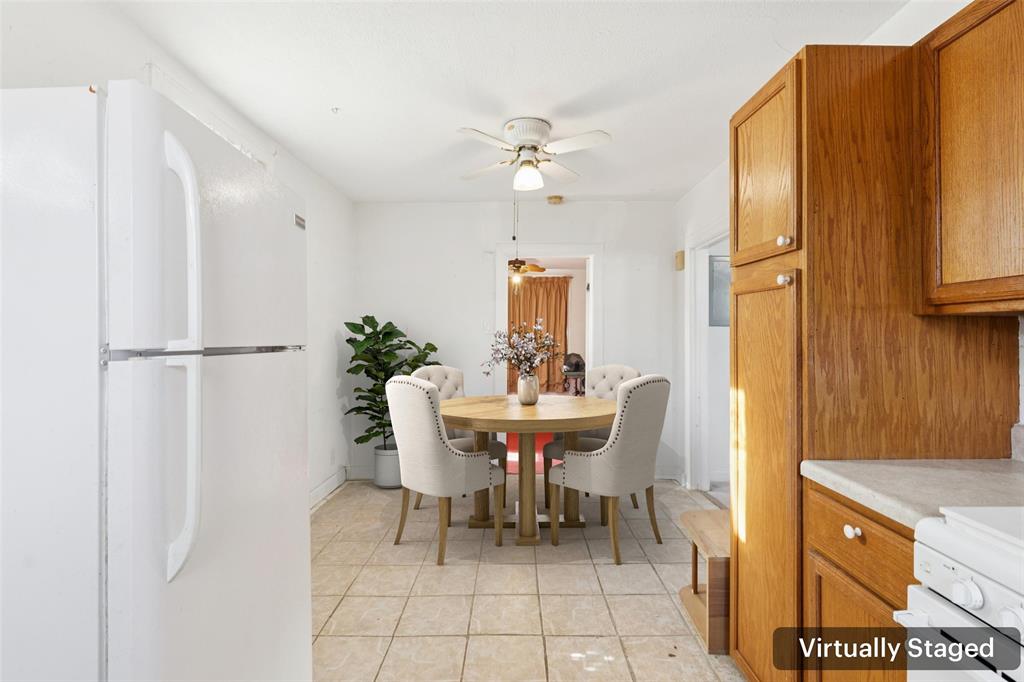 1602 Bruce Drive Garland, TX 75043 - Photo 13 of 31 a dining room with furniture a window and stainless steel appliances