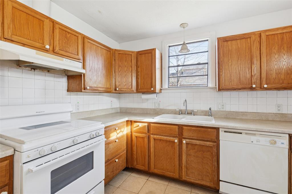 1602 Bruce Drive Garland, TX 75043 - Photo 14 of 31 a kitchen with cabinets appliances a sink and a counter top space