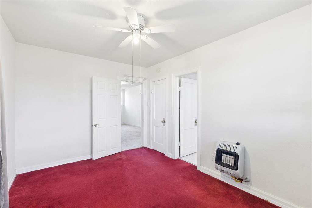 1602 Bruce Drive Garland, TX 75043 - Photo 21 of 31 a bedroom with a bed and a chandelier