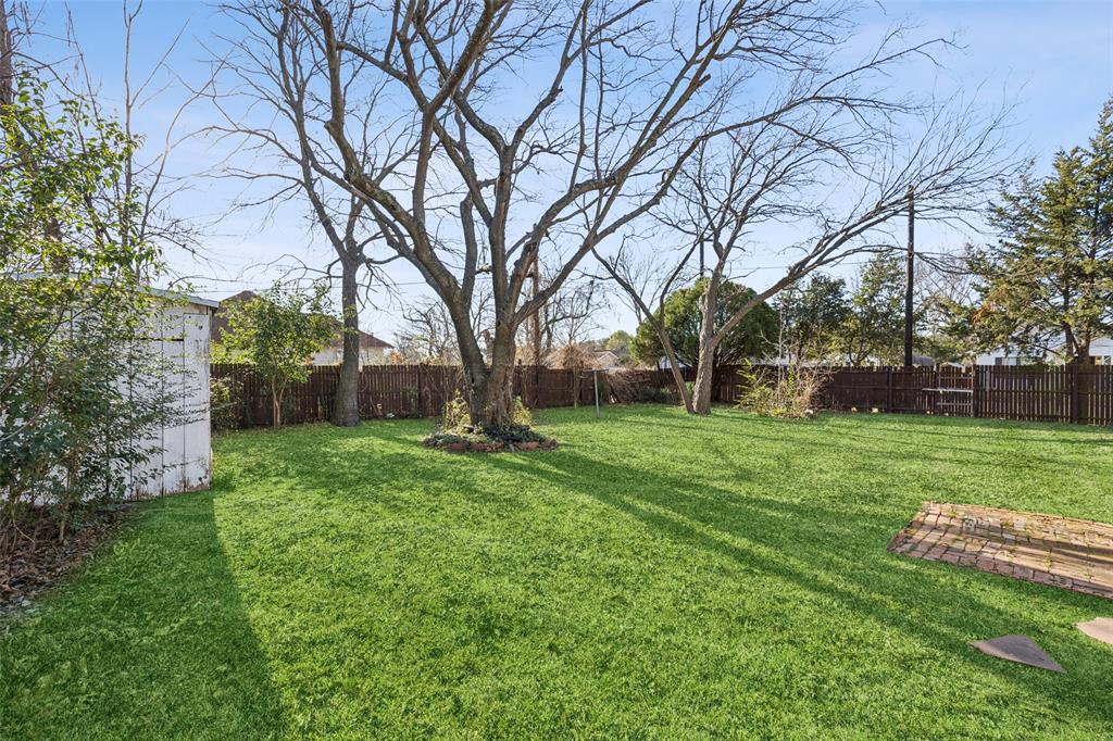 1602 Bruce Drive Garland, TX 75043 - Photo 29 of 31 a view of a backyard with large trees