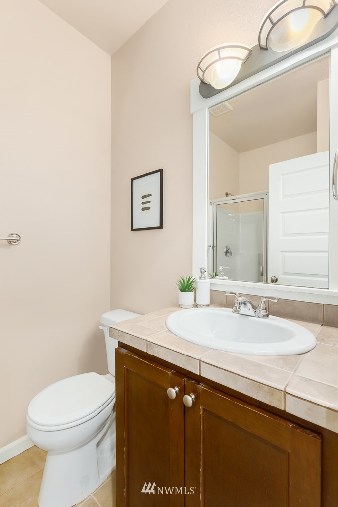 22511 38th Avenue Southeast Bothell, WA 98021 - Photo 14 of 29 a bathroom with a granite countertop toilet sink and mirror