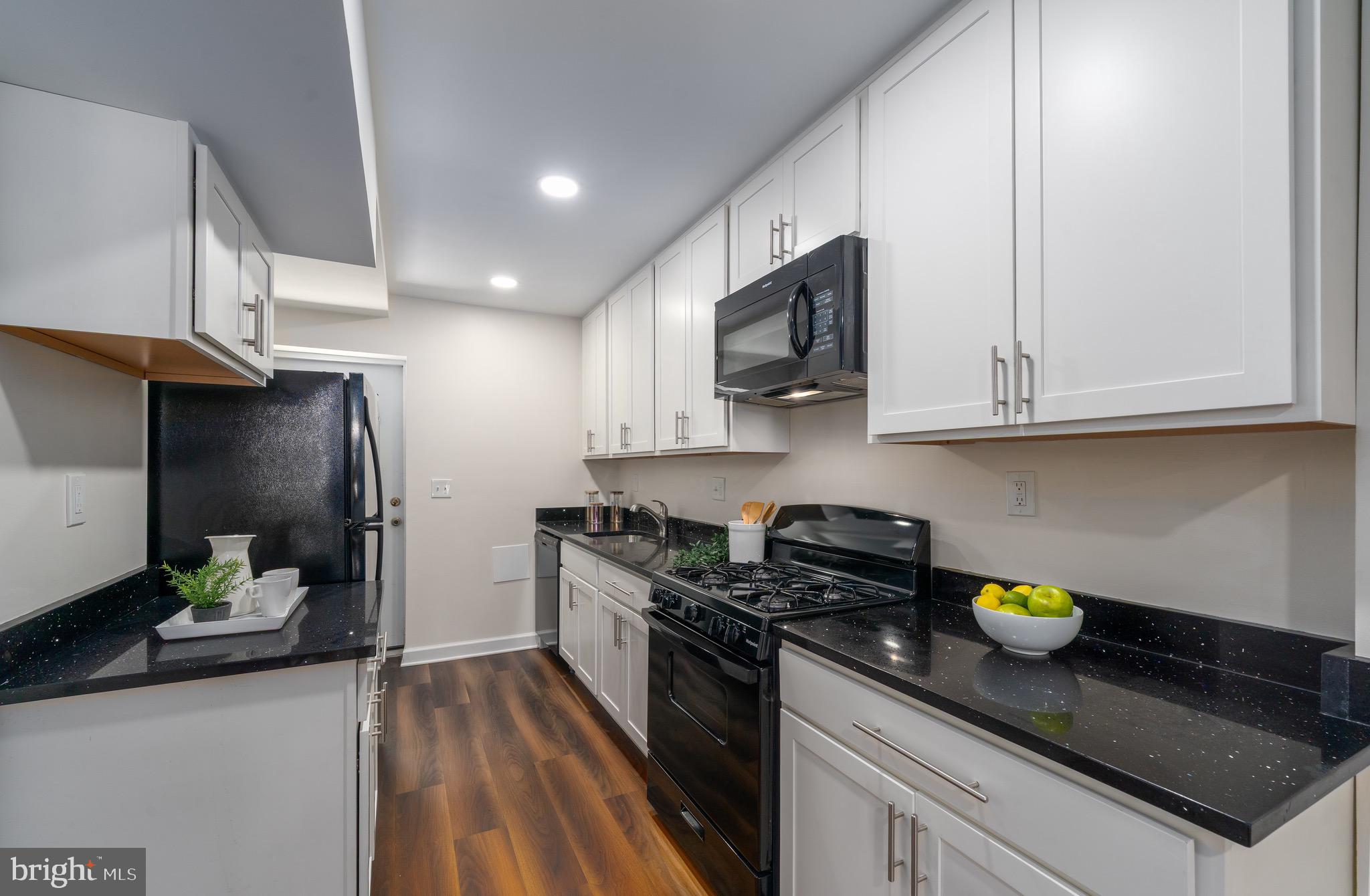 123 East Cross Street Baltimore, MD 21230 - Photo 11 of 33 a kitchen with stainless steel appliances granite countertop a sink a stove cabinets and a counter top space