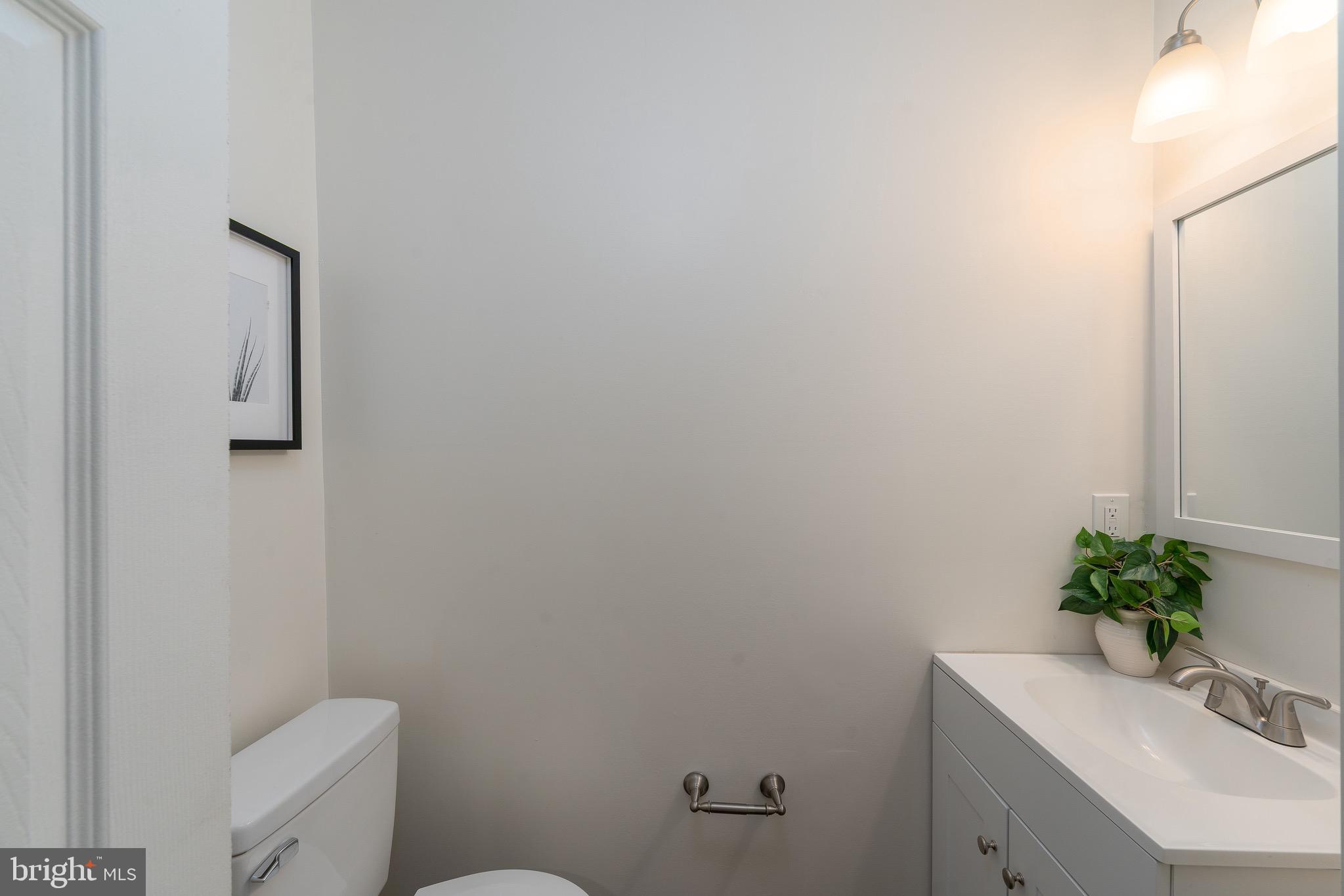 123 East Cross Street Baltimore, MD 21230 - Photo 12 of 33 a bathroom with a sink a toilet and a mirror