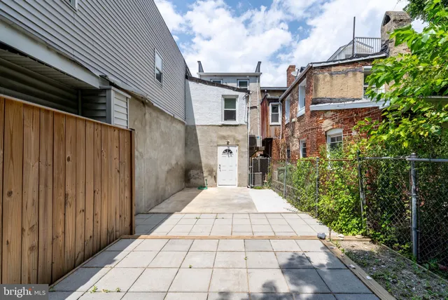 a view of a pathway both side of house