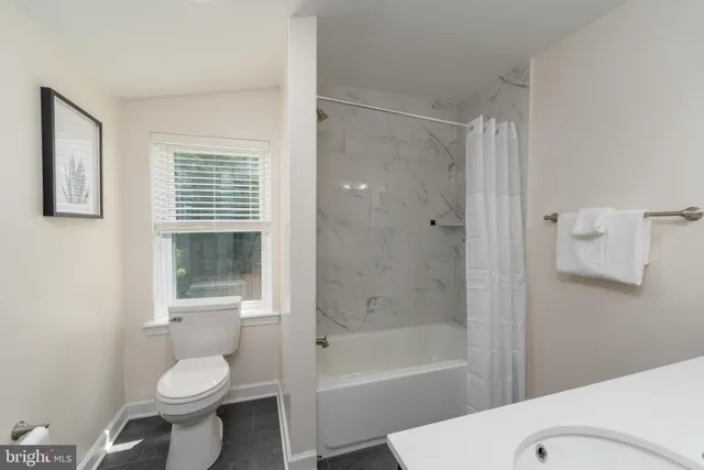 a bathroom with a toilet sink and shower