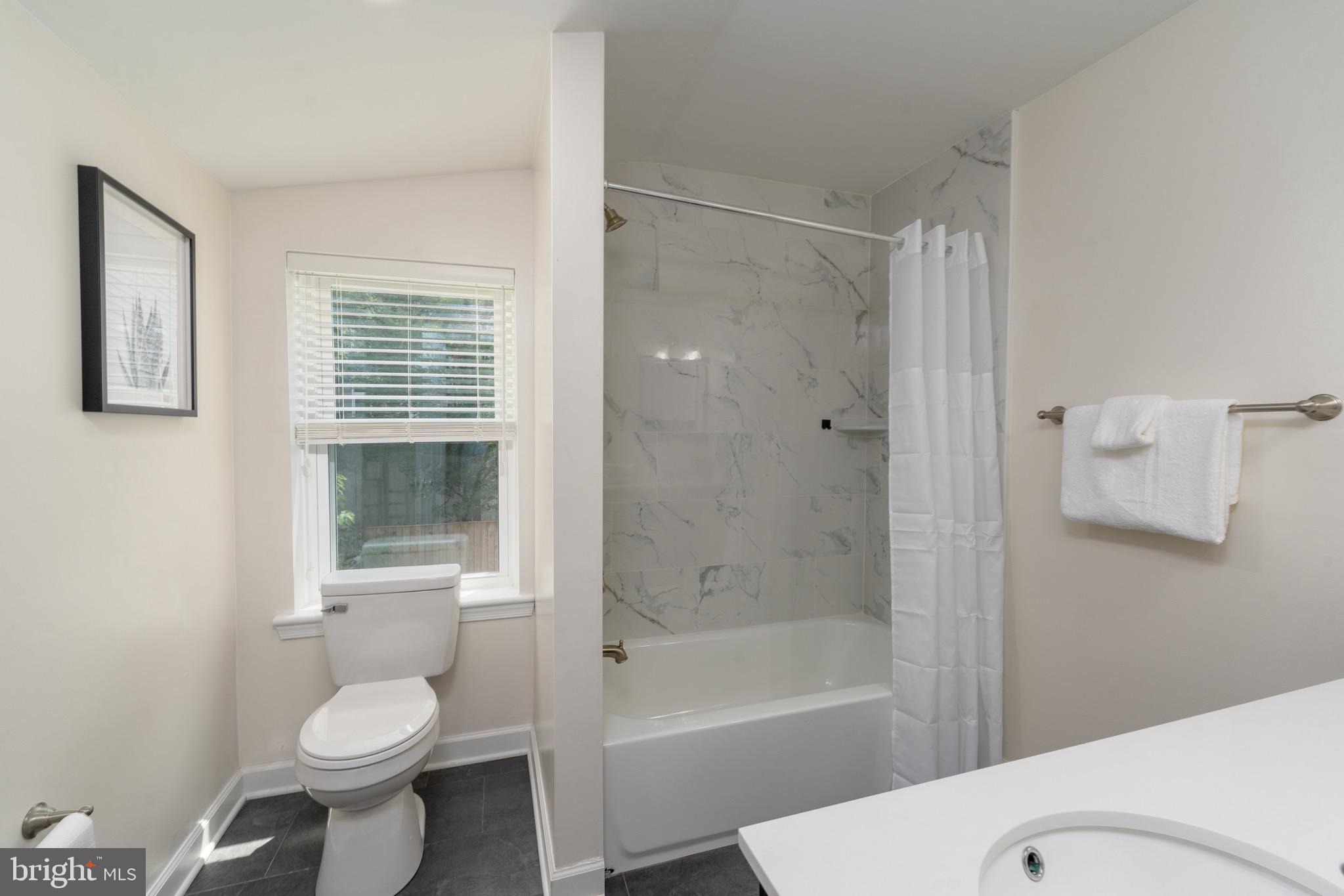 123 East Cross Street Baltimore, MD 21230 - Photo 21 of 33 a bathroom with a toilet sink and shower