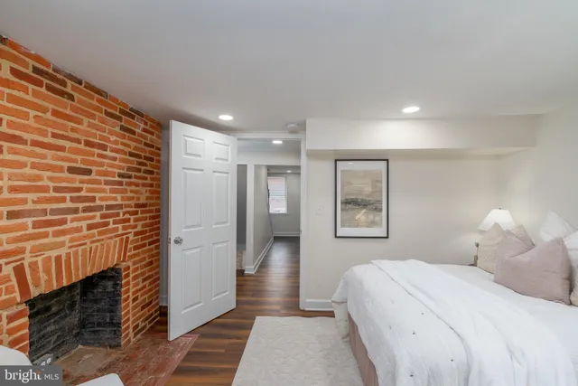 a bedroom with a bed and a fireplace