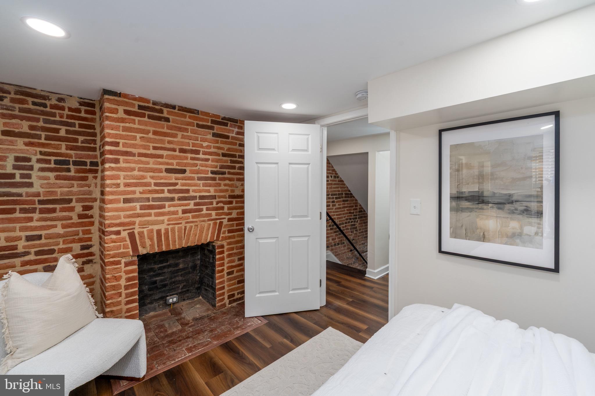 123 East Cross Street Baltimore, MD 21230 - Photo 23 of 33 a bedroom with furniture and a fireplace