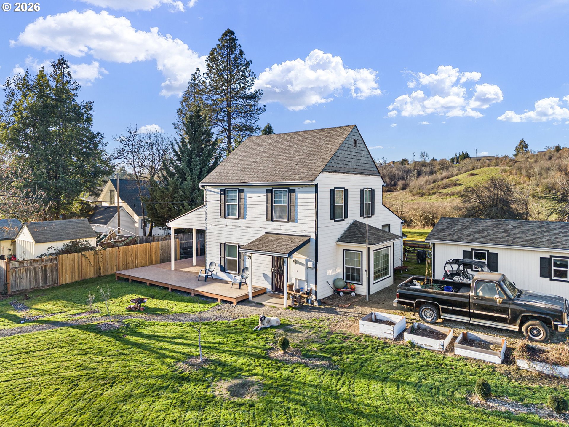 a front view of a house with garden and a swimming pool