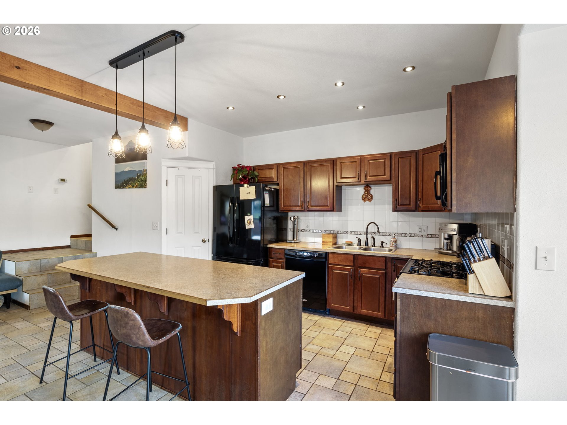 777 Oak Street Oakland, OR 97462 - Photo 19 of 45 a kitchen with a stove a refrigerator a sink a dining table and chairs with wooden floor