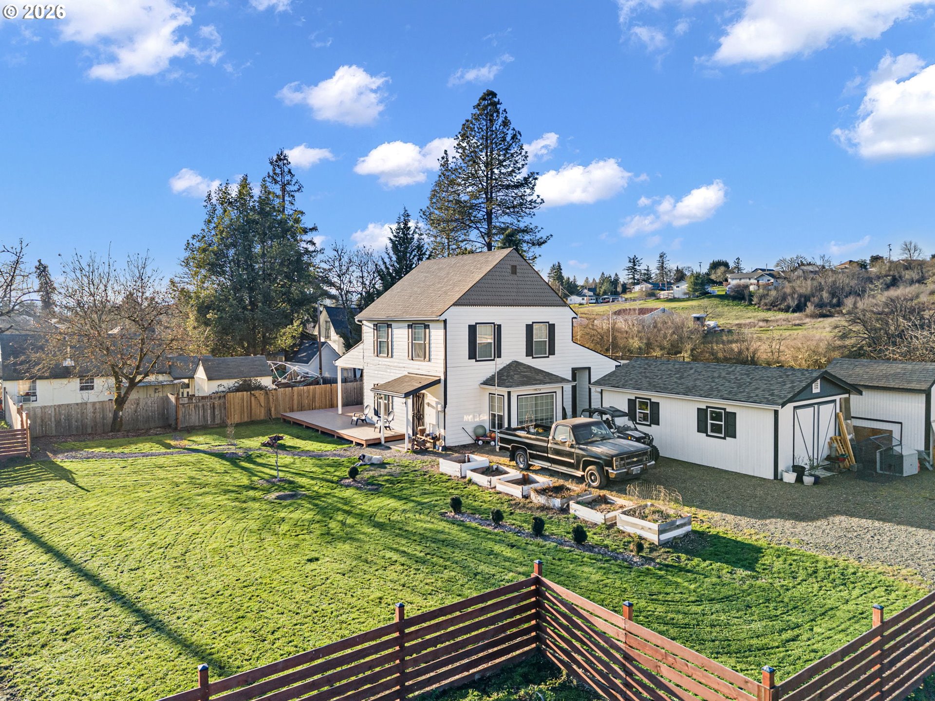 777 Oak Street Oakland, OR 97462 - Photo 30 of 45 a aerial view of a house with swimming pool and a yard
