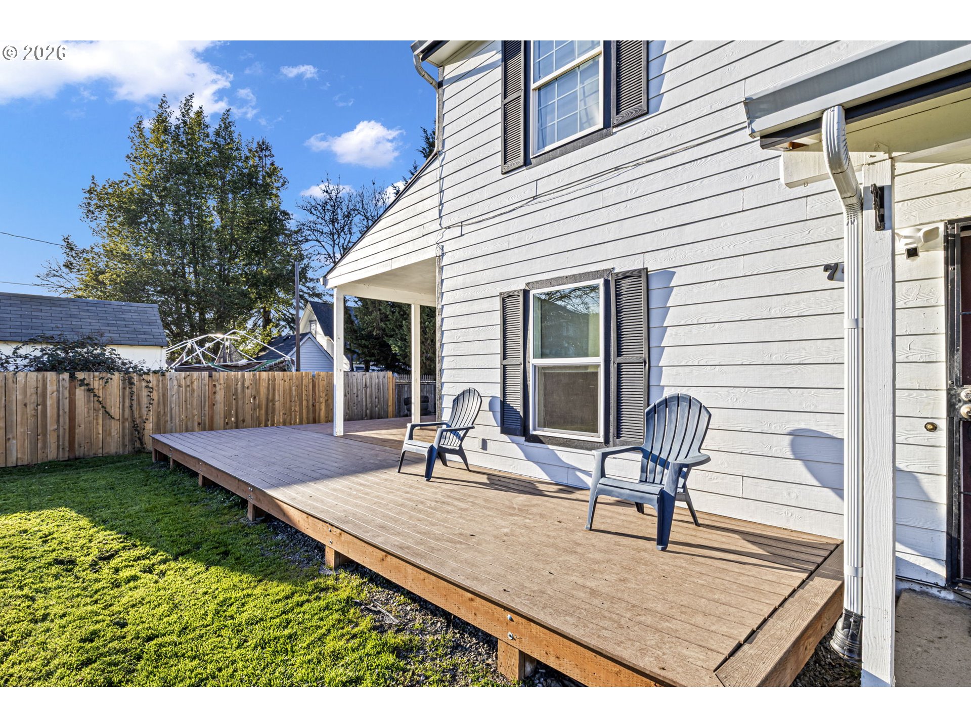 777 Oak Street Oakland, OR 97462 - Photo 36 of 45 a view of a backyard with chairs potted plants and wooden fence