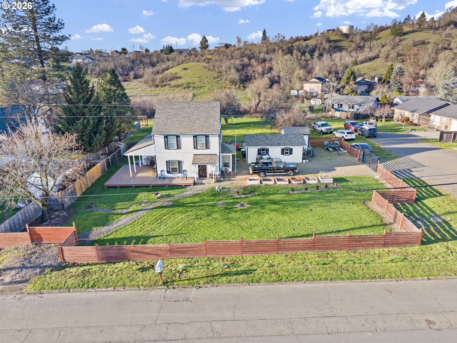 777 Oak Street Oakland, OR 97462 - Photo 38 of 45 a front view of a house with a garden and a yard