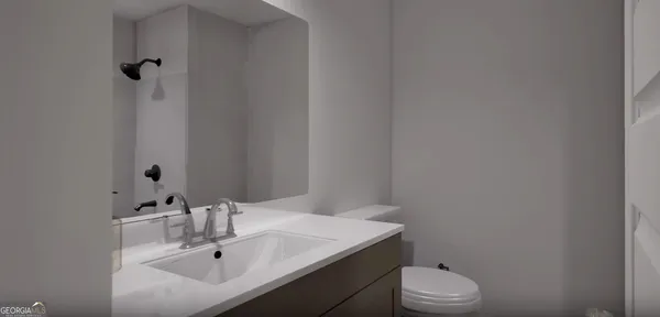 a bathroom with a sink toilet and vanity