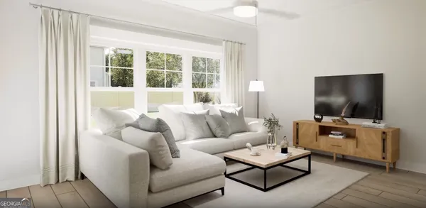 a living room with furniture and a flat screen tv
