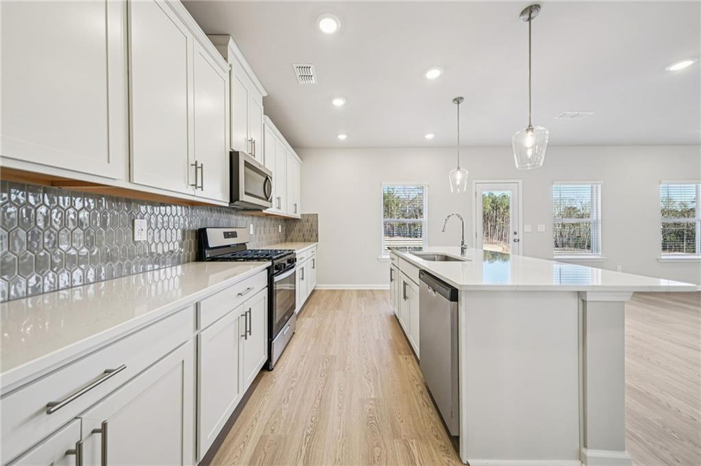 1428 High Fls Lane Grayson, GA 30017 - Photo 13 of 39 a kitchen with kitchen island granite countertop lots of counter top space and sink