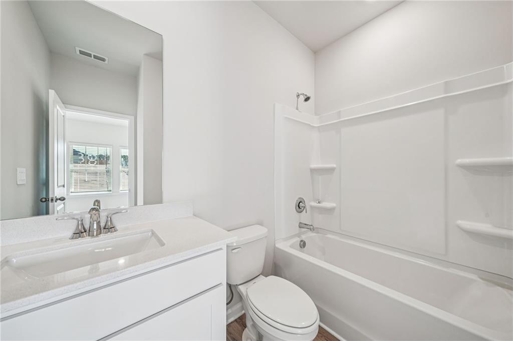 1428 High Fls Lane Grayson, GA 30017 - Photo 16 of 39 a bathroom with a toilet a sink and a bathtub