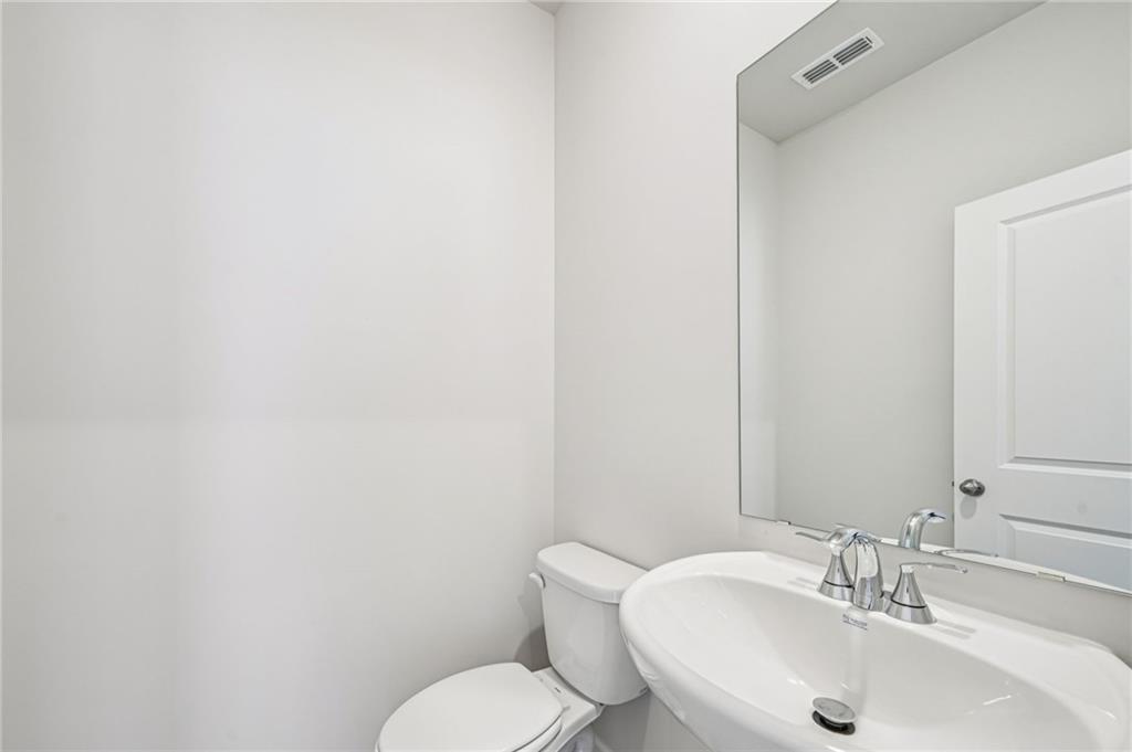 1428 High Fls Lane Grayson, GA 30017 - Photo 18 of 39 a bathroom with a toilet sink and mirror