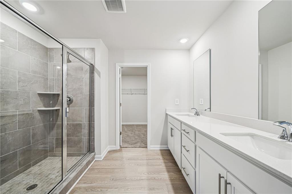 1428 High Fls Lane Grayson, GA 30017 - Photo 25 of 39 a spacious bathroom with a double vanity sink and a mirror