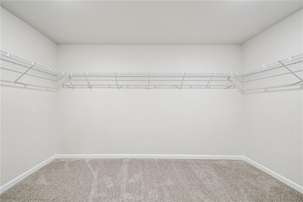 1428 High Fls Lane Grayson, GA 30017 - Photo 26 of 39 a view of a room with racks on the wall