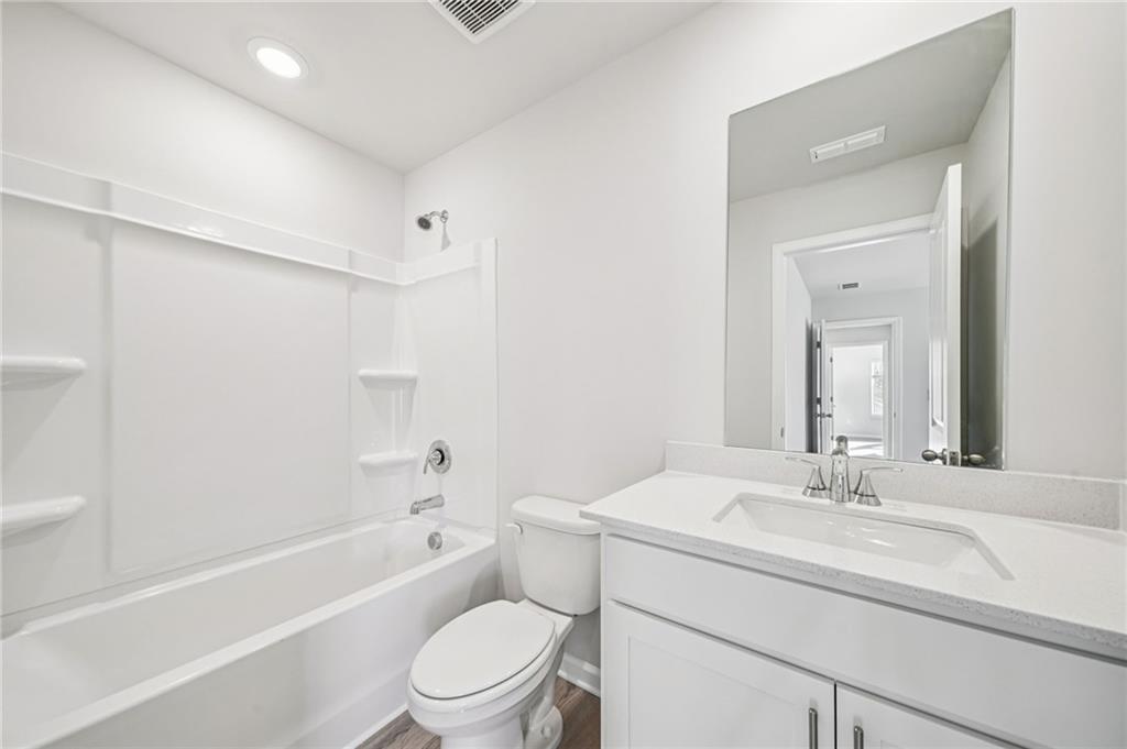 1428 High Fls Lane Grayson, GA 30017 - Photo 30 of 39 a bathroom with a sink a toilet and a bathtub