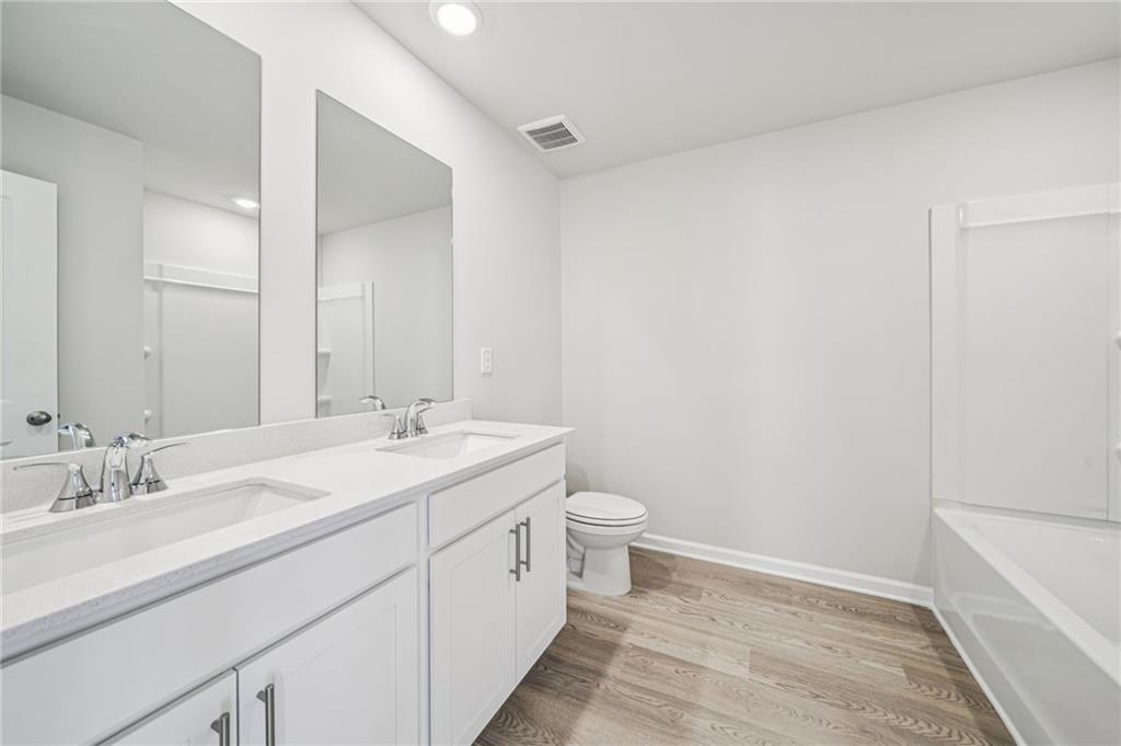 1428 High Fls Lane Grayson, GA 30017 - Photo 31 of 39 a bathroom with a double vanity sink and a mirror
