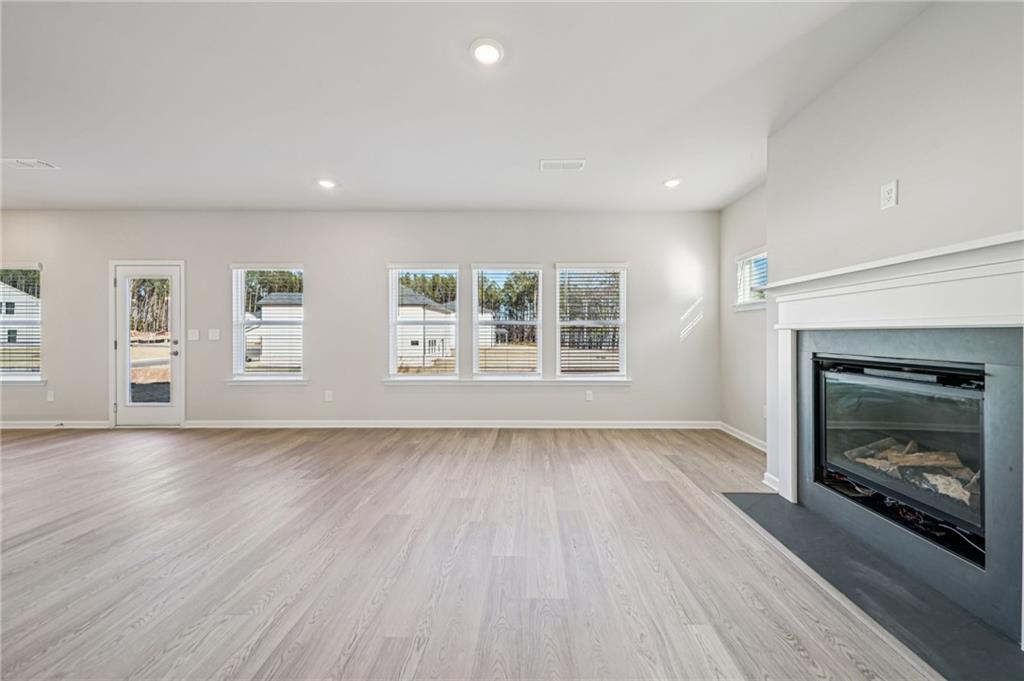 1428 High Fls Lane Grayson, GA 30017 - Photo 8 of 39 an empty room with windows and fireplace