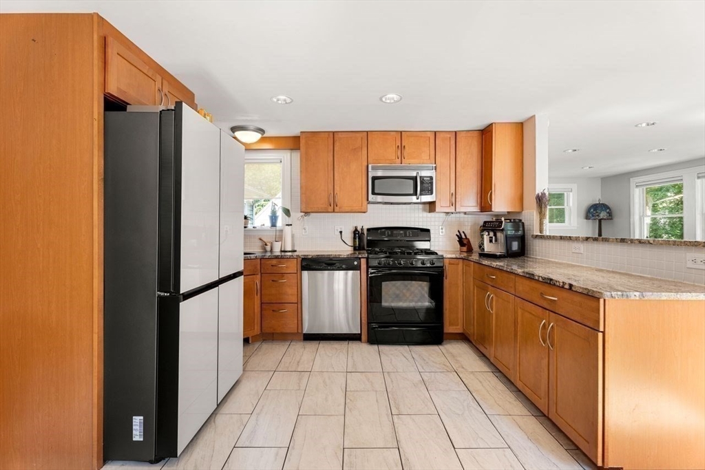 139 Jersey Street Marblehead, MA 01945 - Photo 22 of 42 a kitchen with stainless steel appliances granite countertop a refrigerator sink and stove