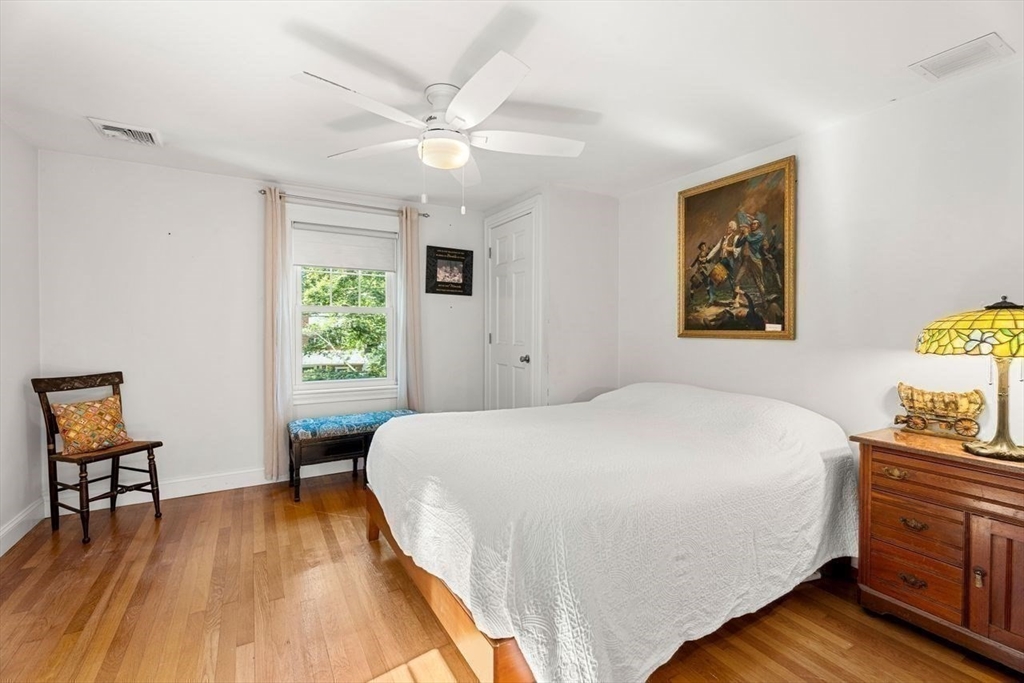 139 Jersey Street Marblehead, MA 01945 - Photo 29 of 42 a bedroom with a bed and a table in it