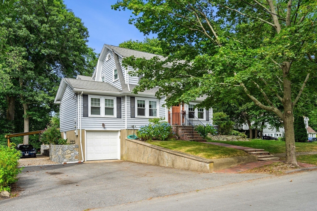139 Jersey Street Marblehead, MA 01945 - Photo 5 of 42 a front view of a house with a yard garage and outdoor seating