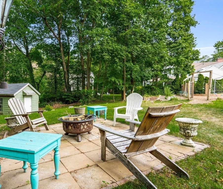 139 Jersey Street Marblehead, MA 01945 - Photo 7 of 42 a view of a patio with table and chairs potted plants and a large tree